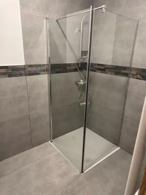 a shower with a glass door in a bathroom at Apartmaji Despotoski Mojstrana in Mojstrana