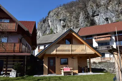 a log cabin with a mountain in the background at Princess Mojca Holiday House in Bled