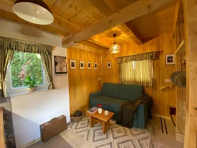 a living room with a couch and a table at Princess Mojca Holiday House in Bled