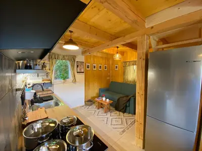 a kitchen and living room of a tiny house at Princess Mojca Holiday House in Bled