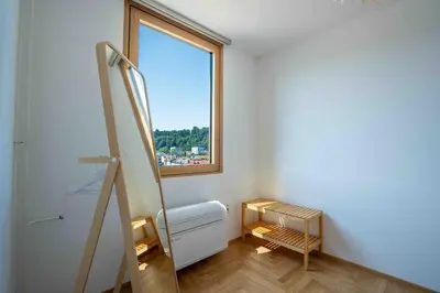 a room with a heater and a window at TJs Temple with Castle View in Ljubljana