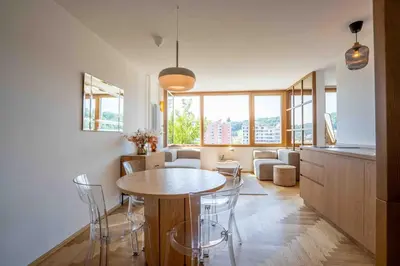 a kitchen and living room with a table and chairs at TJs Temple with Castle View in Ljubljana