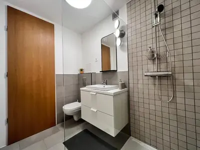 a bathroom with a toilet and a sink and a shower at TJs Temple with Castle View in Ljubljana