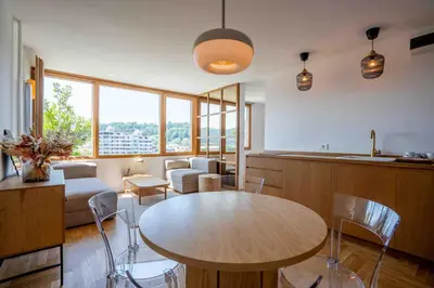 a kitchen and living room with a table and chairs at TJs Temple with Castle View in Ljubljana