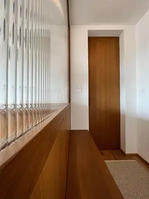 a hallway with a wooden door and a window at TJs Temple with Castle View in Ljubljana
