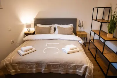 a bedroom with a large bed with towels on it at Apartments Villa Prod in Ljubljana
