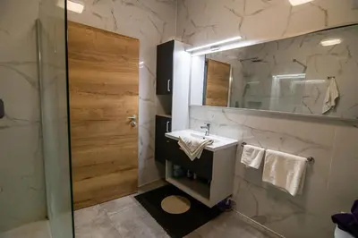 a bathroom with a sink and a mirror at Apartments Villa Prod in Ljubljana