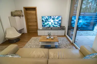 a living room with a couch and a flat screen tv at Apartments Villa Prod in Ljubljana