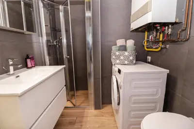a bathroom with a sink and a toilet and a shower at Secret Corner in Ljubljana