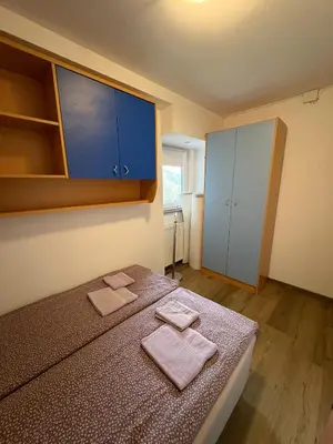 a bedroom with a bed with two towels on it at Apartma Vinko in Ljubljana