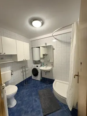 a bathroom with a toilet and a sink and a tub at Apartma Vinko in Ljubljana