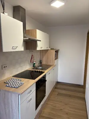 a kitchen with white cabinets and a sink at Apartma Vinko in Ljubljana