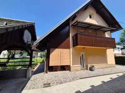 a building with a basketball hoop in front of it at Hiša JAVORNIK BOHINJ in Bohinj