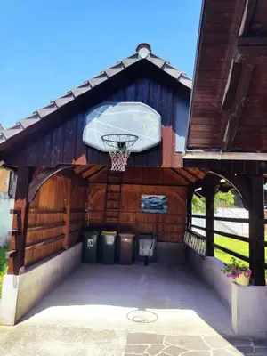an outdoor basketball hoop in a wooden building at Hiša JAVORNIK BOHINJ in Bohinj