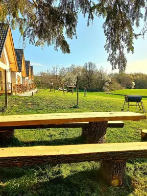 a wooden bench in a field with a park at Oaza miru in zdravja Goričko in Moravske Toplice