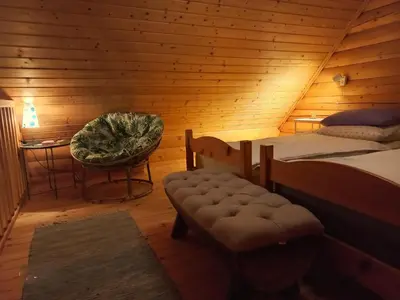 a bedroom with a bed and a chair in a room at Oaza miru in zdravja Goričko in Moravske Toplice