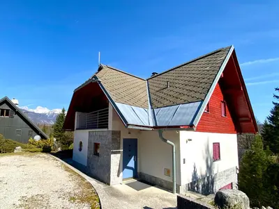 a red and white barn with a red roof at Bohinj Cozy Escape Holiday Home in Bohinj