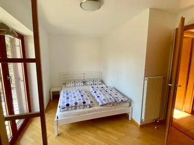 a white bed in a room with bottles on it at Bohinj Cozy Escape Holiday Home in Bohinj
