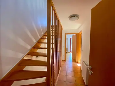 a staircase in a house with a hallway at Bohinj Cozy Escape Holiday Home in Bohinj