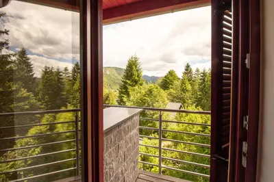 a window with a view of the mountains at Bohinj Cozy Escape Holiday Home in Bohinj