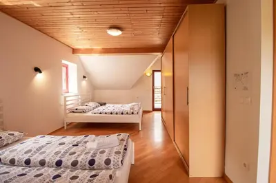 a bedroom with two beds and a hallway at Bohinj Cozy Escape Holiday Home in Bohinj
