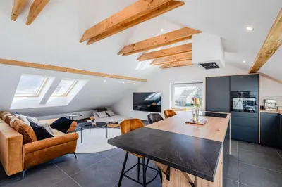 a living room with a couch and a table at Alps2sea Apartment House in Srpenica