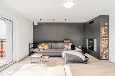 a living room with a couch and a table at Alps2sea Apartment House in Srpenica