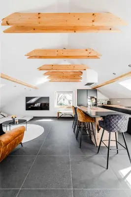 an open living room with a table and chairs at Alps2sea Apartment House in Srpenica