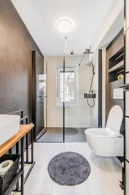 a bathroom with a white toilet and a sink at Alps2sea Apartment House in Srpenica