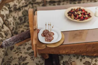 a table with a plate of food and a bowl of nuts at Harmony Resort in Cerklje na Gorenjskem