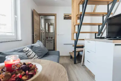 a living room with a bowl of food on a table at Harmony Resort in Cerklje na Gorenjskem