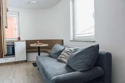 a living room with a couch and a table at Harmony Resort in Cerklje na Gorenjskem