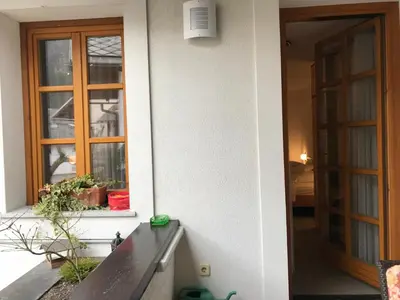 a door to a house with a bench and a window at Apartmaji Sušnik in Bled