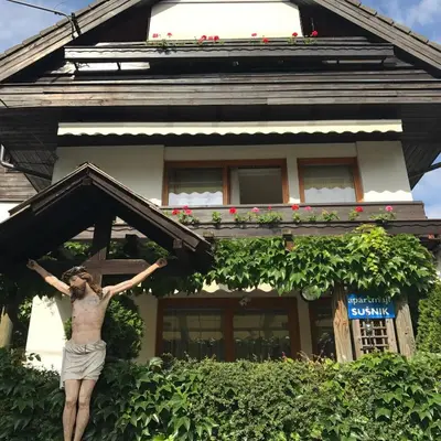 a man standing in front of a house at Apartmaji Sušnik in Bled