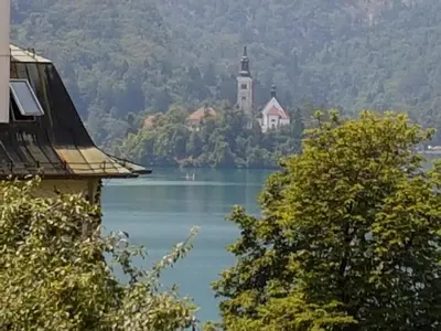 a church on a island in the middle of a lake at Apartmaji Sušnik in Bled
