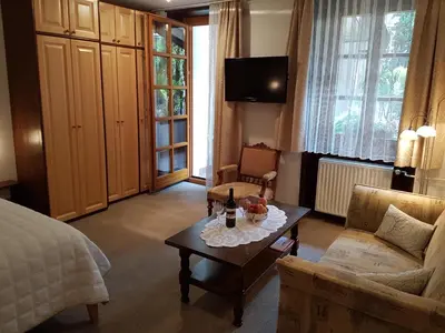 a living room with a bed and a coffee table at Apartmaji Sušnik in Bled