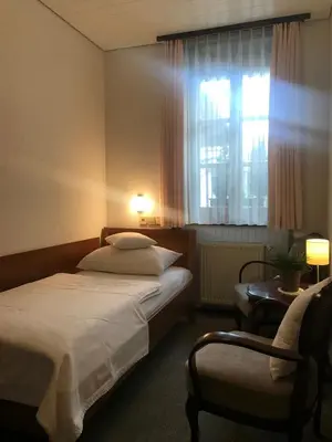 a hotel room with a bed and a window at Apartmaji Sušnik in Bled