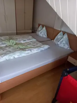 a bed in a room with two pillows on it at Apartment Zorec in Maribor