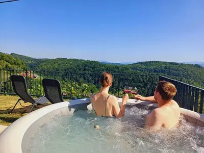 a man and a woman sitting in a hot tub at Holiday home in Trebnje - Kranjska (Krain) 53751 in Trebnje