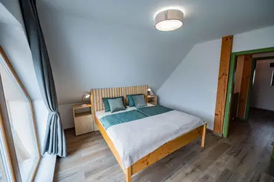a bedroom with a bed with blue pillows on it at Holiday home in Trebnje - Kranjska (Krain) 53751 in Trebnje