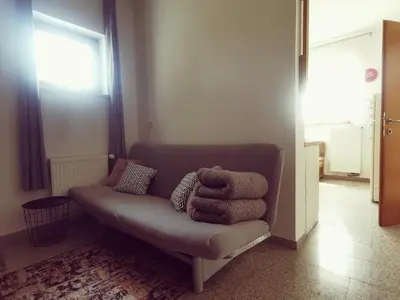 a couch in a living room with towels on it at Apartma Pristavica in Veliki Gaber