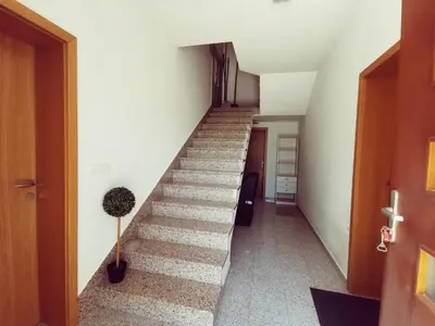 a stairway in a building with a hallway at Apartma Pristavica in Veliki Gaber