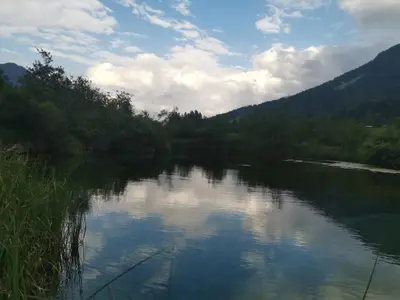 a view of a river with mountains in the background at Apartma Confine in Rateče