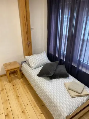 a bed with pillows on it in a room at Apartma Confine in Rateče