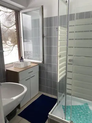 a bathroom with a tub and a sink and a shower at Apartma Confine in Rateče