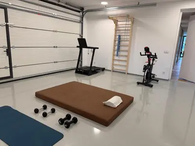 a room with a gym with a treadmill and a rug at Smart & Wellness Villa in Ptuj