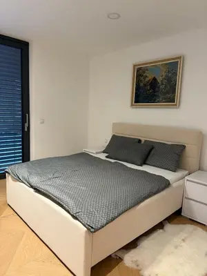 a bed in a bedroom with a picture on the wall at Smart & Wellness Villa in Ptuj