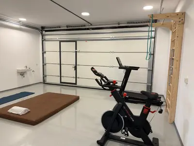 a gym with a treadmill and a exercise bike at Smart & Wellness Villa in Ptuj