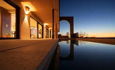 a building with a pool of water in front of it at Villa EVA Resort & Boutique in Dobrovo