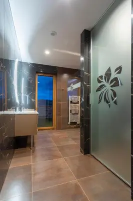 a bathroom with a sink and a mirror at Villa EVA Resort & Boutique in Dobrovo